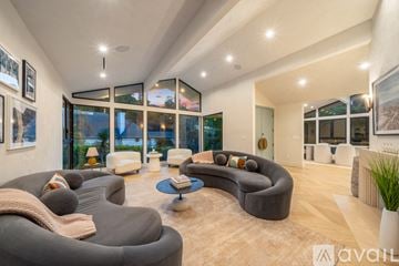 Beverly Hills house for rent - A modern living room with a grey sofa and a coffee table.