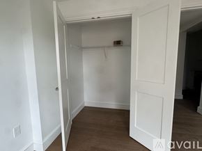 Cambridge apartment for rent - A white door is open to a room with a wooden floor.