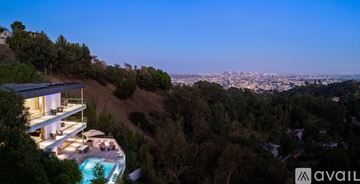 Los Angeles house for rent - A modern living room with a glass table and yellow chairs.
