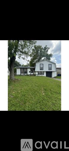 Westerville house for rent - A living room with a brown couch and a black coffee table.
