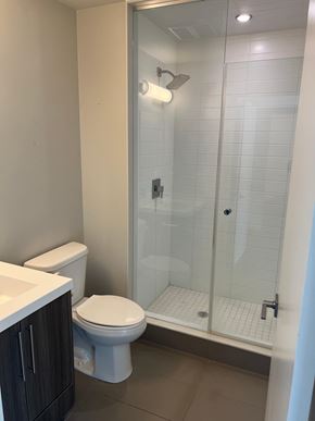 Burlington apartment for rent - A white toilet sits next to a sink in a bathroom.