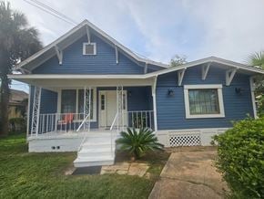 Pensacola house for rent - A blue house with white trim and a white porch.