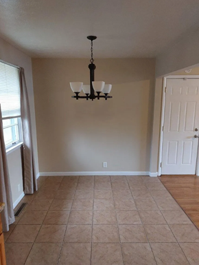 Lima house for rent - A room with a chandelier and a door.