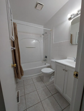 Lima house for rent - A white bathroom with a toilet, sink, and shower.