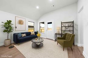 Greenville house for rent - A living room with a blue couch, a green armchair, and a coffee table.