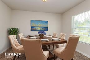 Conroe house for rent - A dining room with a wooden table and chairs, a painting on the wall, and a potted plant on the left.