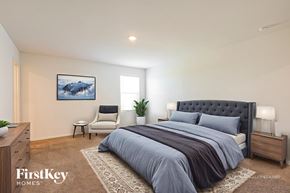 New Braunfels house for rent - A bedroom with a large bed and a painting on the wall.