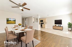 Rockwall house for rent - A dining room with a table set for six and a painting on the wall.
