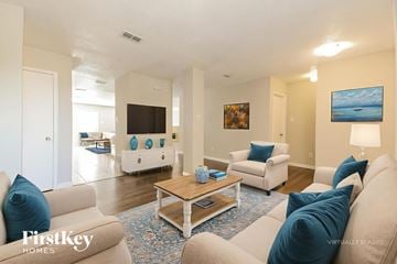 Rockwall house for rent - A living room with a beige couch and a coffee table.