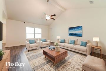 Dallas house for rent - A living room with a couch, a coffee table, and a painting on the wall.