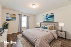 Dallas house for rent - A bedroom with a large bed and a painting on the wall.