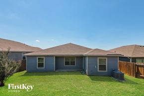 Dallas house for rent - A house with a blue exterior and a brown roof is shown with the words "FirstKey Homes" on the bottom left.