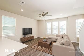 Shenandoah house for rent - A spacious living room with a television and a couch.
