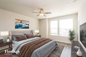 Shenandoah house for rent - A bedroom with a large bed and a painting on the wall.