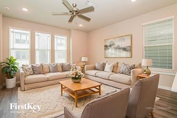 Shenandoah house for rent - A living room with a large sectional sofa, a coffee table, and a painting on the wall.