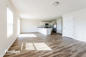 Conroe house for rent - A spacious kitchen and living room with wooden floors and white walls.