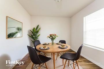 Conroe house for rent - A dining room with a wooden table and chairs.