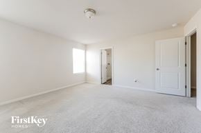 Conroe house for rent - A spacious room with a carpeted floor and white walls.