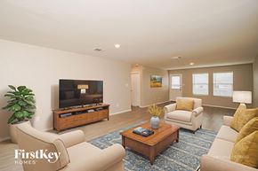 New Braunfels house for rent - A living room with a flat screen TV and a coffee table.