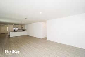 New Braunfels house for rent - A spacious, empty room with wooden flooring and white walls.