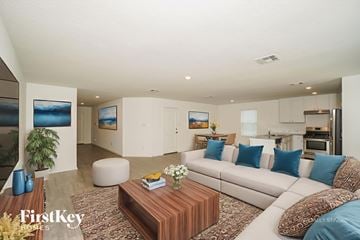 New Braunfels house for rent - A modern living room with a white sofa and a wooden coffee table.