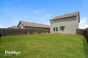 New Braunfels house for rent - A house with a fence and a grassy yard.