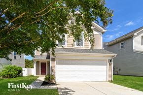 Charlotte house for rent - A house with a brown roof and a white garage door is for sale.