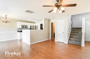 Charlotte house for rent - A spacious living room with a staircase leading to the upper floor.