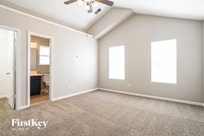 Charlotte house for rent - A spacious room with a ceiling fan and three windows.