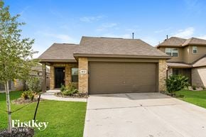 Baytown house for rent - A house with a brown garage door is for sale.