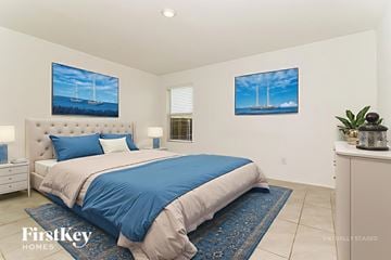 Princeton house for rent - A bedroom with a large bed and two paintings on the wall.