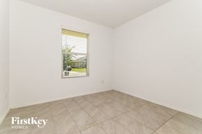 Princeton house for rent - A room with a window showing a view of a house and trees outside.