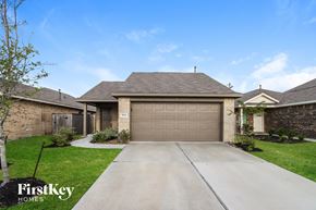 Baytown house for rent - A house with a garage and a driveway in front of it.