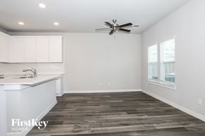 Shenandoah house for rent - A spacious kitchen with a fan and wooden flooring.