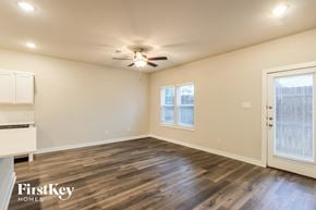 Shenandoah house for rent - A spacious room with wooden flooring and a ceiling fan.