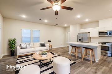 Shenandoah house for rent - A modern living room with a white couch and a wooden coffee table.