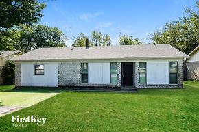 Rockwall house for rent - A white house with a black roof and a green lawn in front.