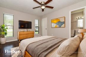 Rockwall house for rent - A bedroom with a bed, dresser, and a painting on the wall.