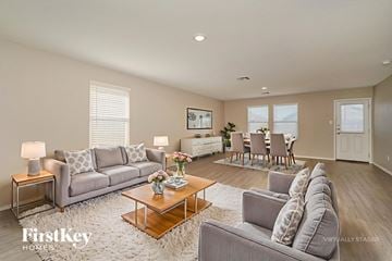 New Braunfels house for rent - A living room with a grey couch, a coffee table, and a painting on the wall.