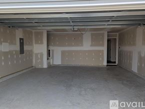 New Bern house for rent - A spacious empty room with drywall installation in progress.