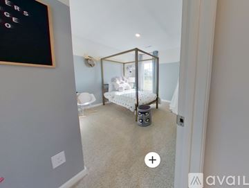New Bern house for rent - A bedroom with a bed and a chair in it.