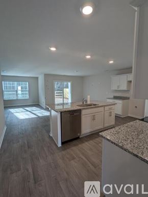 New Bern house for rent - A kitchen with a granite countertop and wooden flooring.