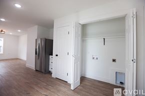 Berryville house for rent - A kitchen with a fridge and a door open to another room.