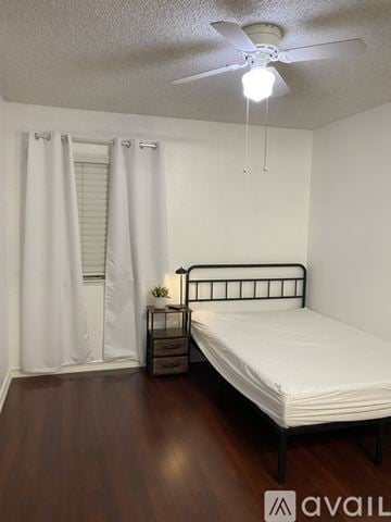 Moreno Valley house for rent - A kitchen with white cabinets and a wooden table.
