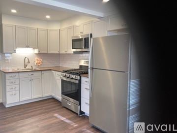 Haverstraw apartment for rent - A living room with a grey couch and a television on a cabinet.