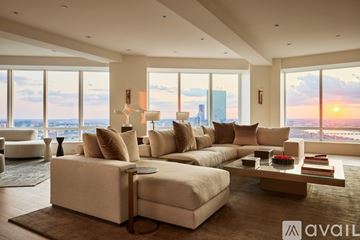 Boston apartment for rent - A modern living room with a large sectional sofa and a coffee table.