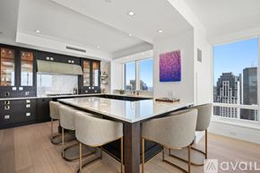 Boston apartment for rent - A modern kitchen with a large island and chairs.