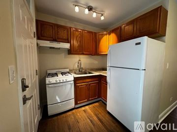 Chicago apartment for rent - A kitchen with white cabinets and appliances.
