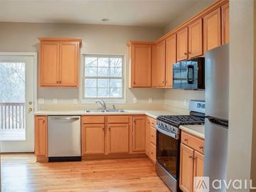 Sewickley house for rent - A kitchen with wooden cabinets and a stainless steel refrigerator.