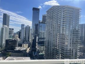 Miami condo for rent - A cityscape with tall buildings and a clear sky.